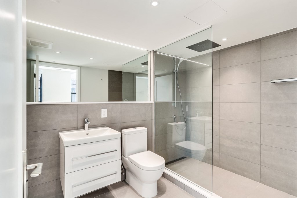 Luxury bathroom with spa inspired shower and extra large mirror