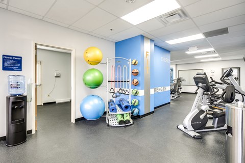 fitness center with exercise equipment and weights