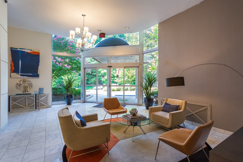 A living room with a glass table and chairs.