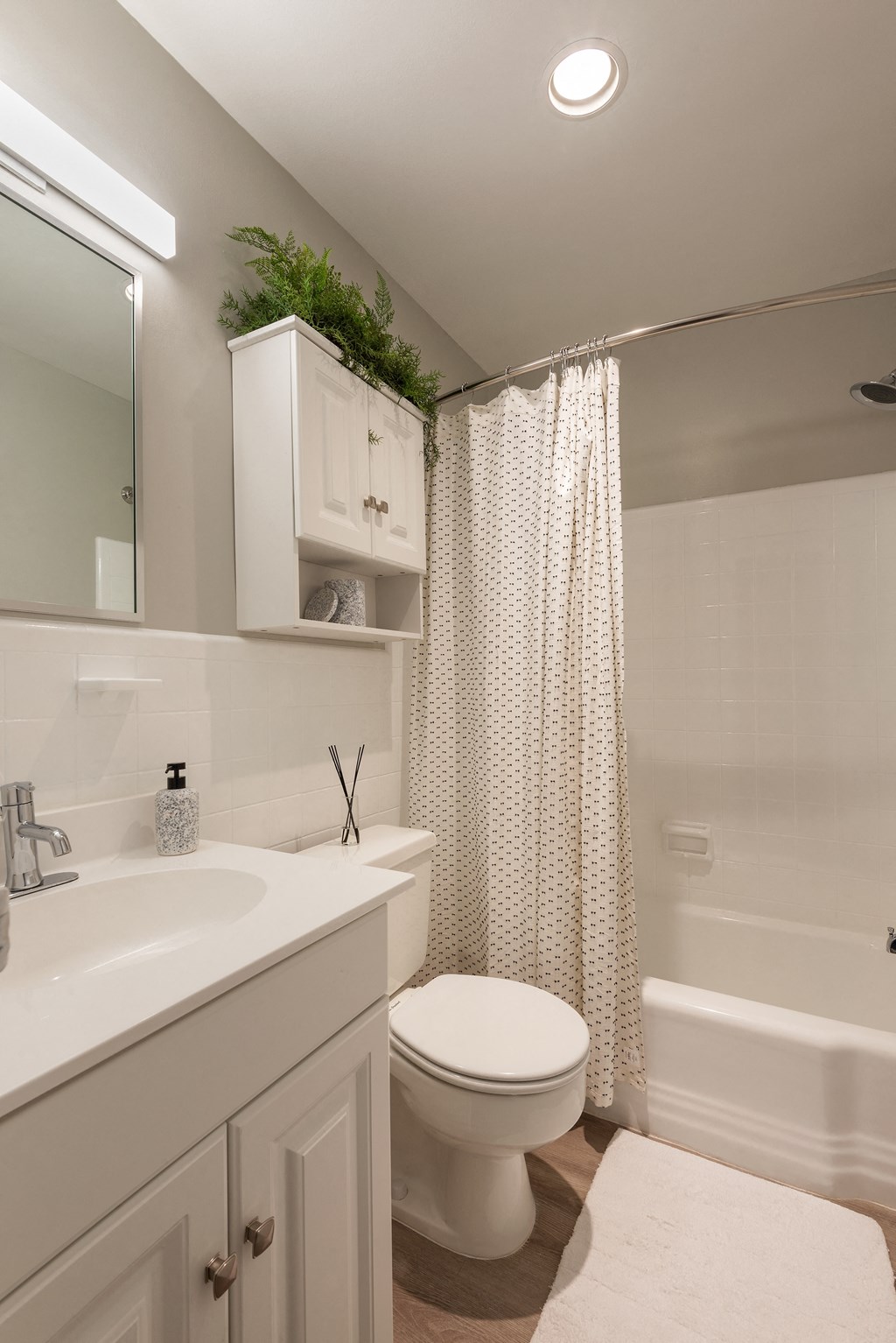 a bathroom with a toilet and a shower and a sink