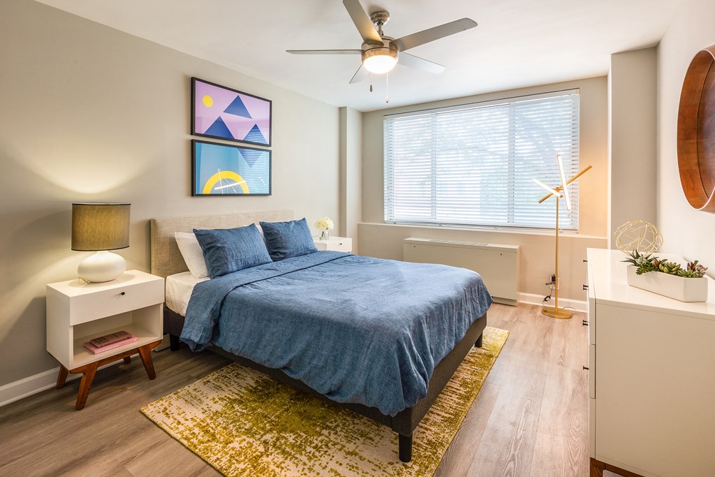 a bedroom with a bed and a ceiling fan