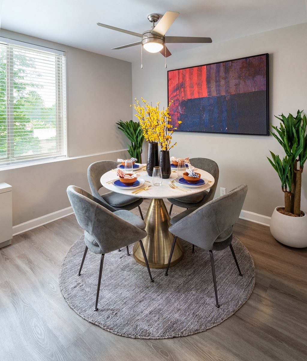 an image of a dining room with a table and chairs