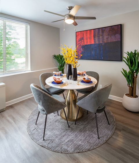 an image of a dining room with a table and chairs