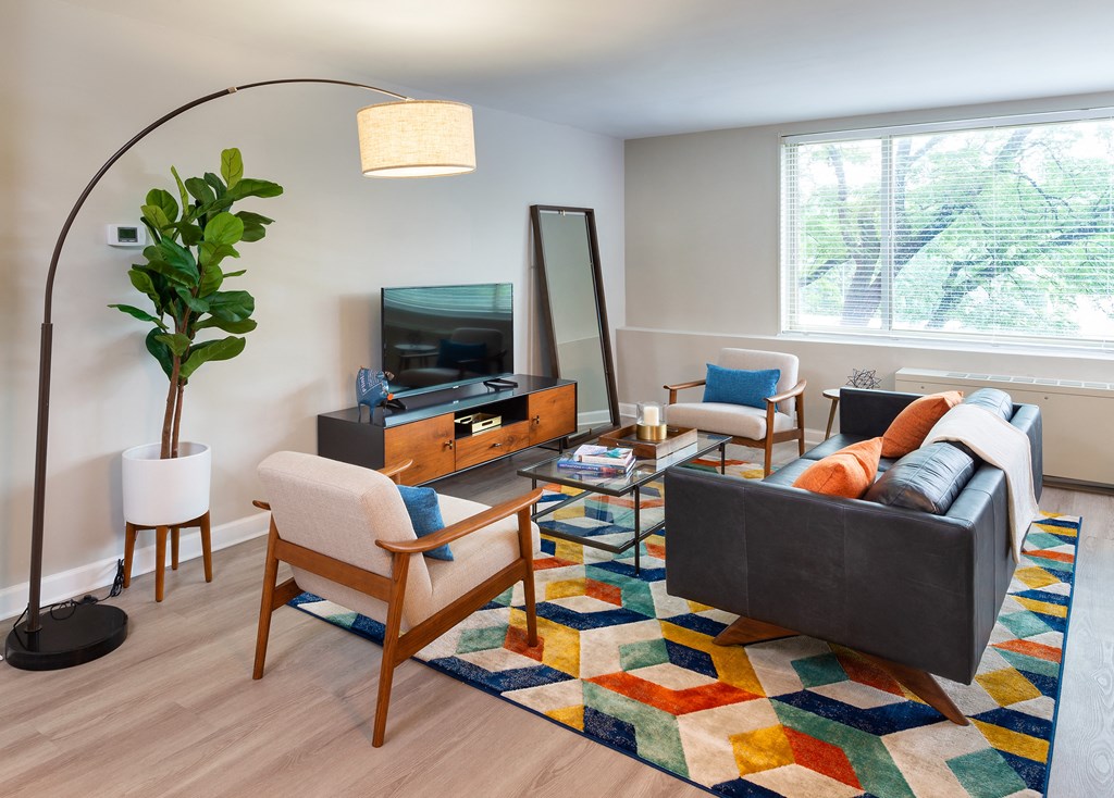 a living room with a couch and chairs and a television