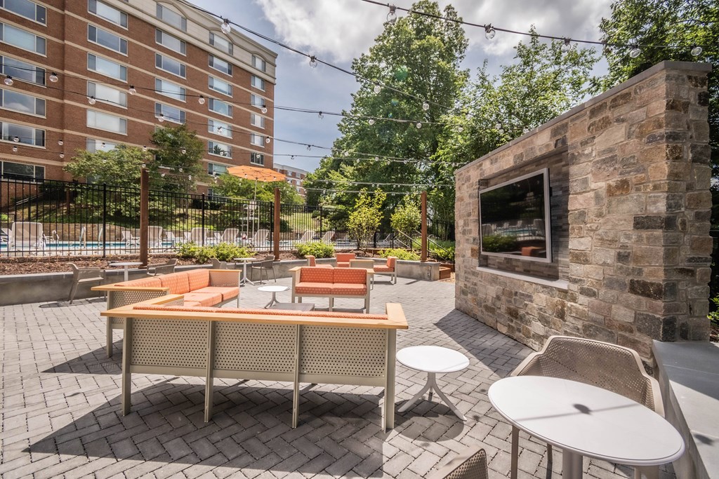 a patio with a table and chairs and a fire pit