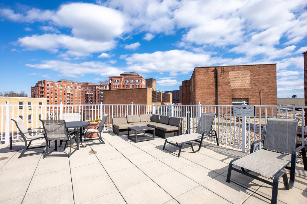 A patio with chairs and a table is set up on a rooftop.