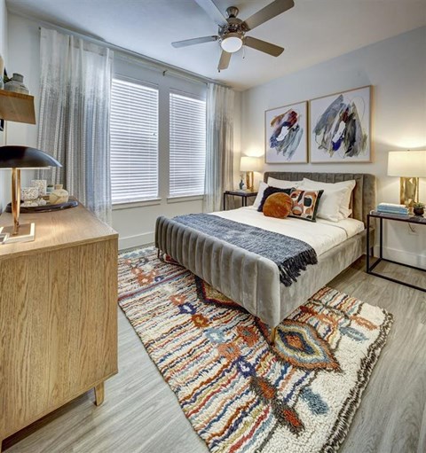 a bedroom with a bed and a ceiling fan