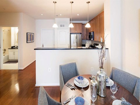 a dining room table with a kitchen in the background