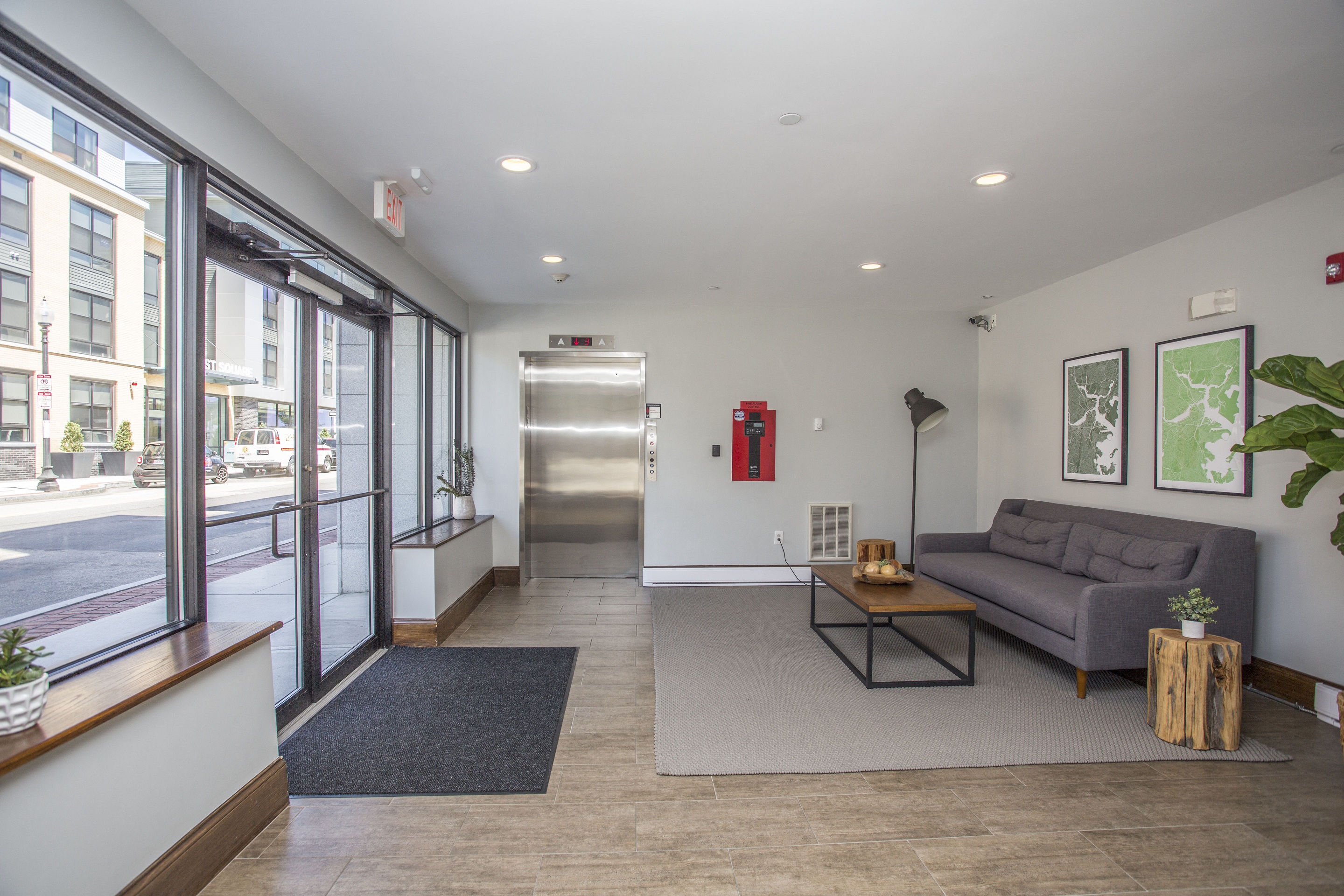 a living room with a couch and a coffee table in front of glass doors