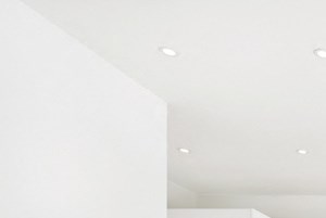 A kitchen with white cabinets and a wooden floor.
