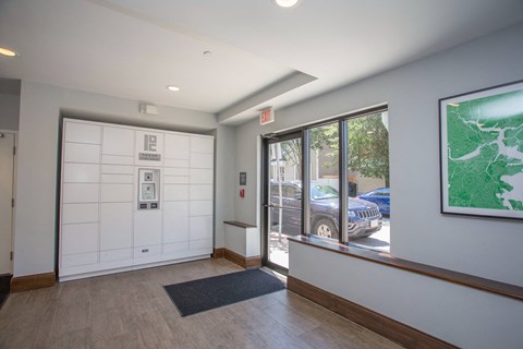 a lobby with a white door and a window with a car parked outside