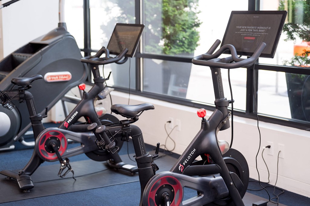 a group of exercise bikes in a gym