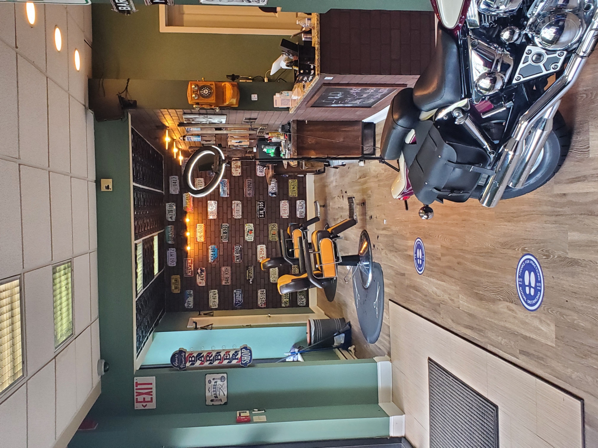 a motorcycle is hanging from the ceiling of a bar with tools on the wall