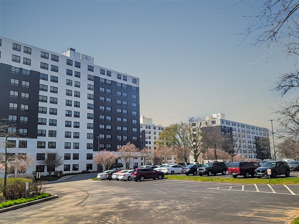 a parking lot with two buildings in the background