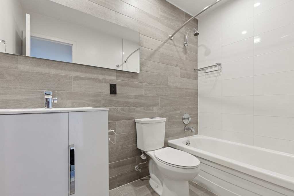 Full bathroom with tub and shower combo, sink and toilet