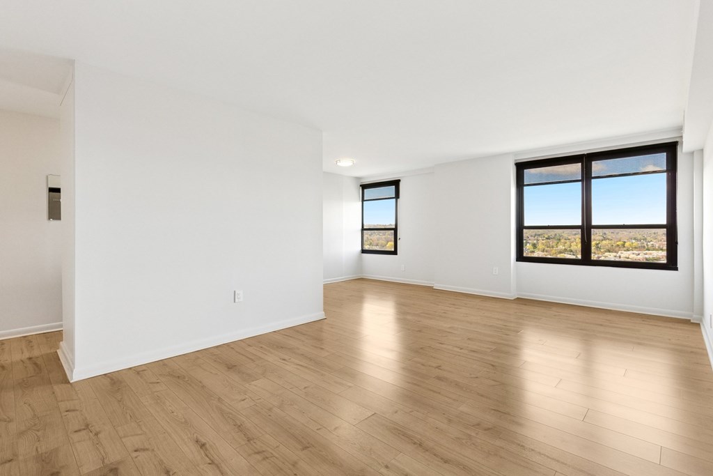 Sunlit living area in unit WPH20 at 251 Dekalb Apartments in King of Prussia, PA, featuring a comfortable sofa, modern décor, large window, and soft natural lighting