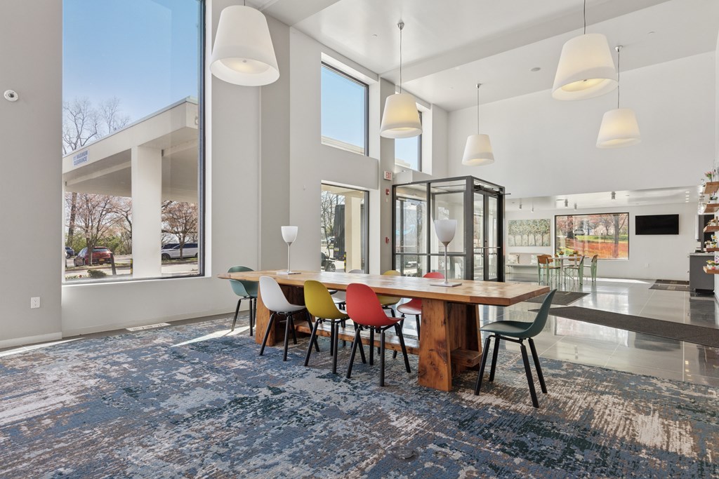 A modern dining room with a large table and chairs.
