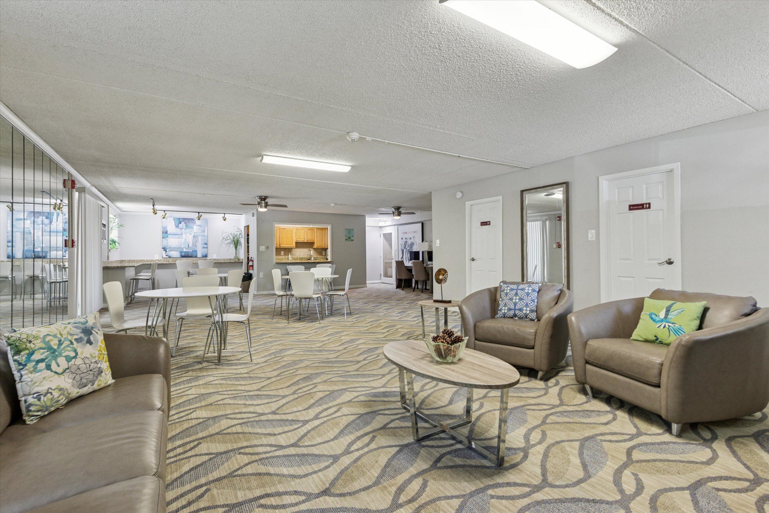 A living room with a patterned carpet and furniture.