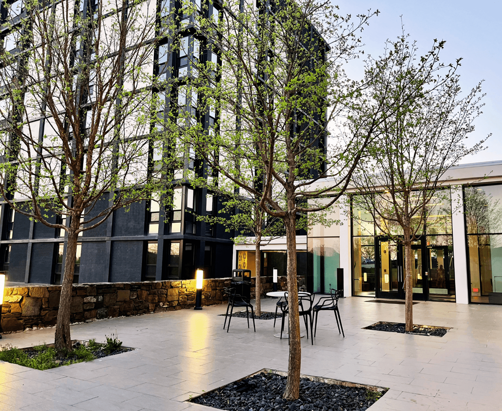 a terrace with tables and chairs in front of a building