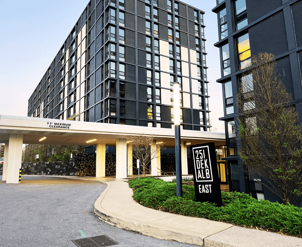 a sign in front of a tall building