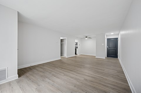 A room with a wooden floor and white walls.
