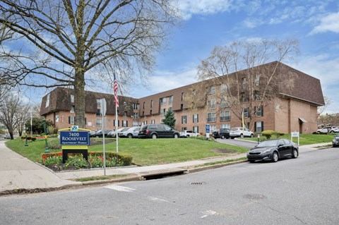 A large building with a sign that says "7400 Roosevelt" in front of it.