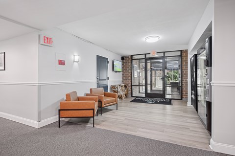 A hallway with a bench, a door, and a sign that says "EXIT".