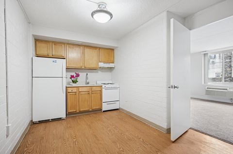 A kitchen with wooden cabinets and white appliances.