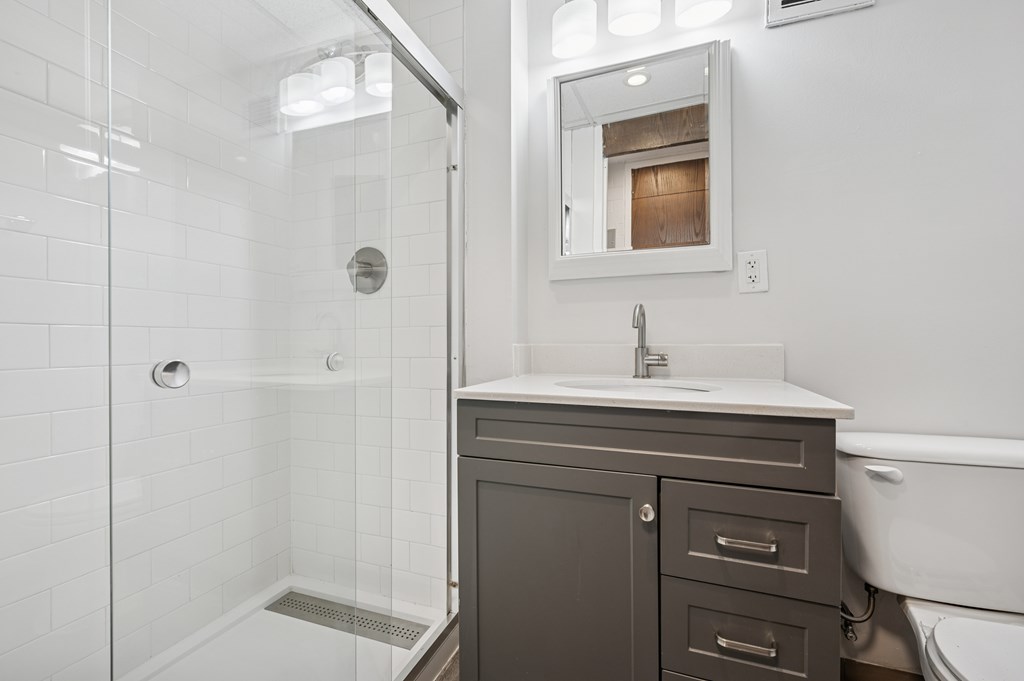 A white bathroom with a white tub and a white sink.