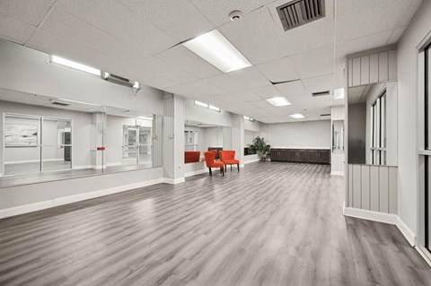 A spacious office room with wooden floors and white walls.