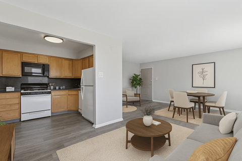 A kitchen with wooden cabinets and a white refrigerator is shown.