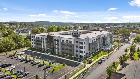 A large white building with a parking lot in front of it.