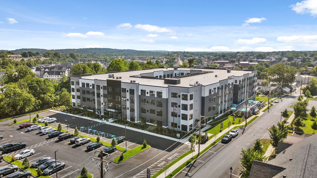 A large white building with a parking lot in front of it.
