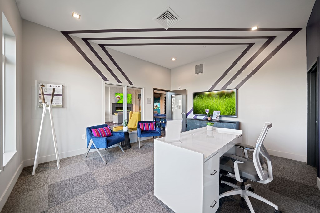A room with a white desk and a white chair.