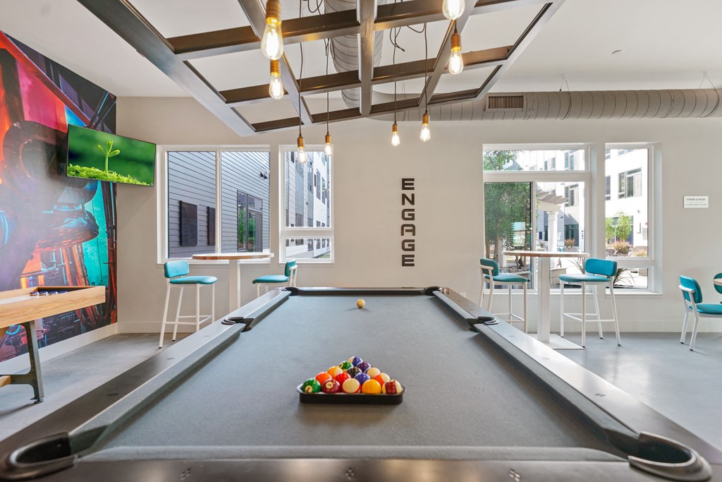 A pool table with a tray of balls on it.