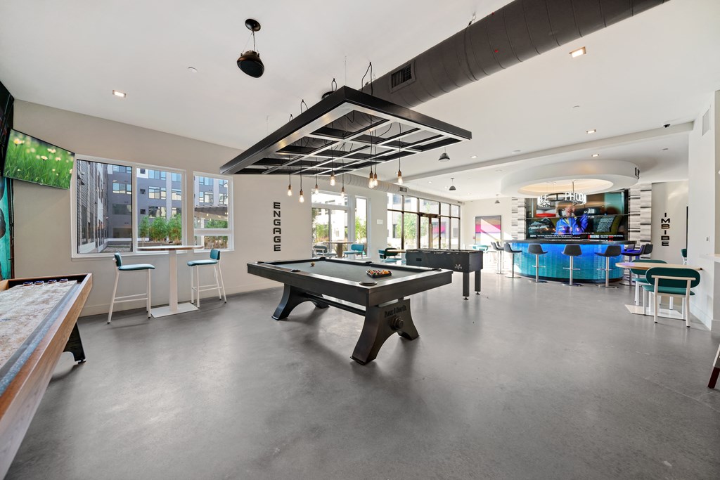 A billiard table is in the middle of the room.