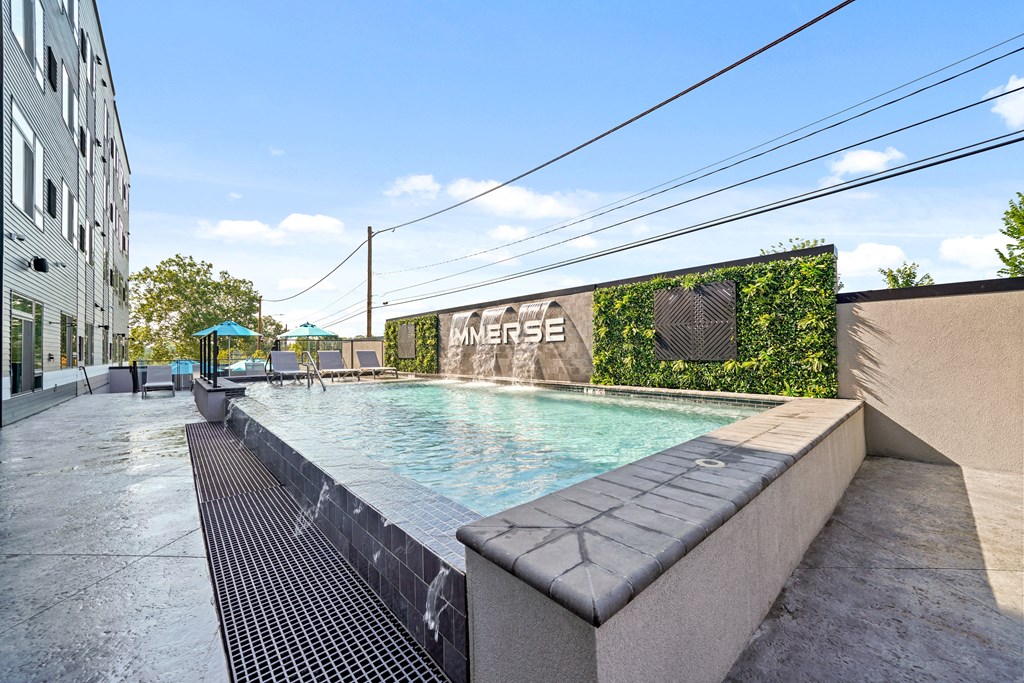 A pool with a green wall on the side and the word "WERSE" on it.