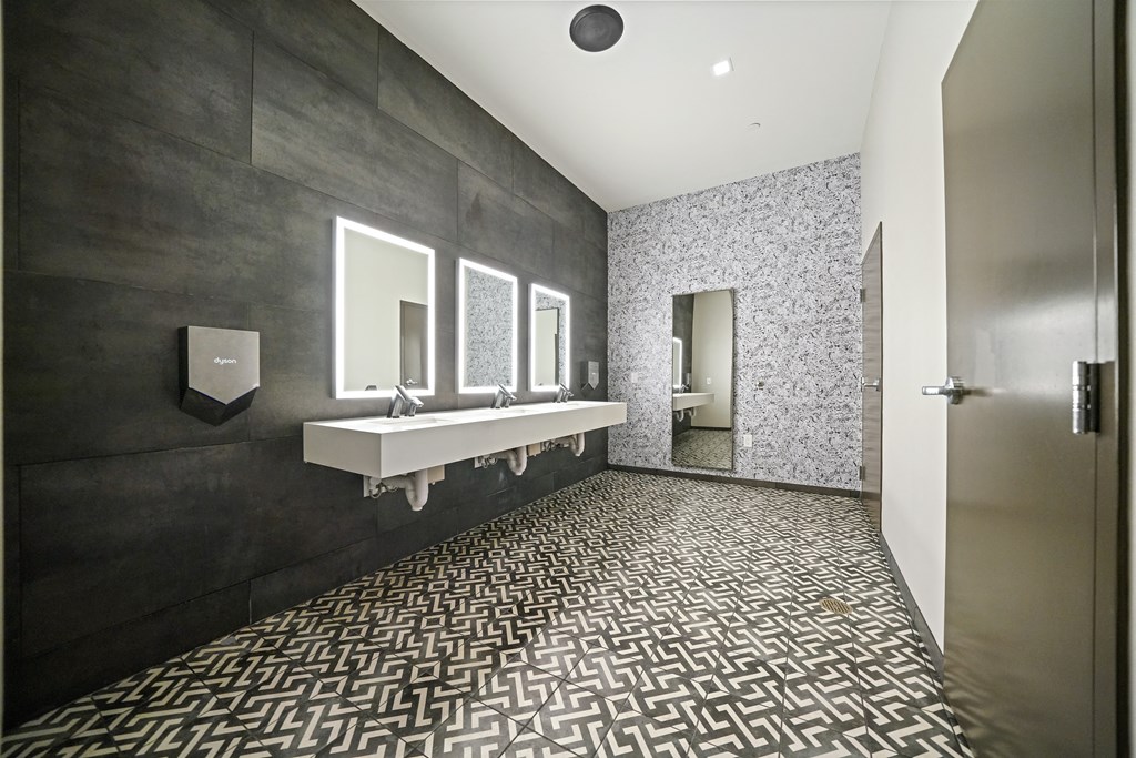 A bathroom with a black and white tiled floor.