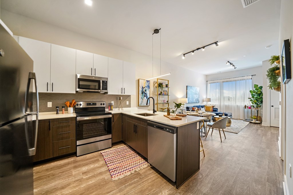 A modern kitchen with stainless steel appliances and wooden cabinets.