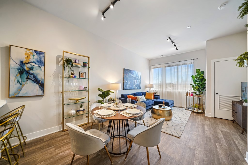 A dining room with a round table and chairs.