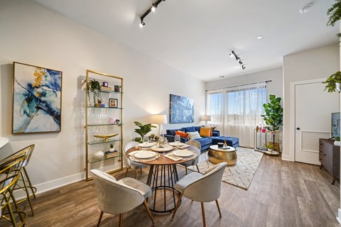 A dining room with a round table and chairs.