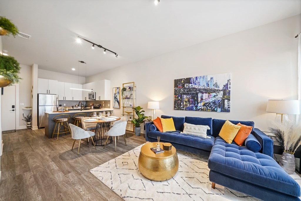 A living room with a blue couch and a coffee table.