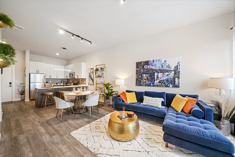 A living room with a blue couch and a coffee table.