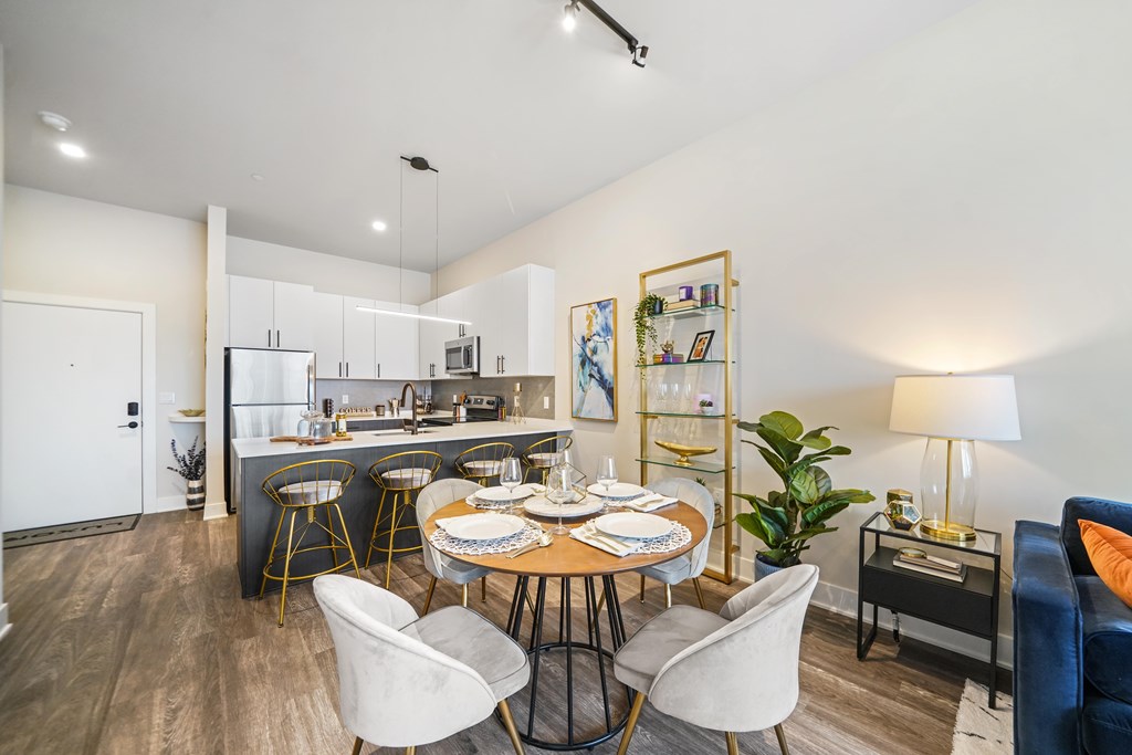 A modern kitchen with a dining table set for four.