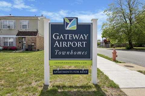 A sign for Gateway Airport Townhomes with a website listed below.