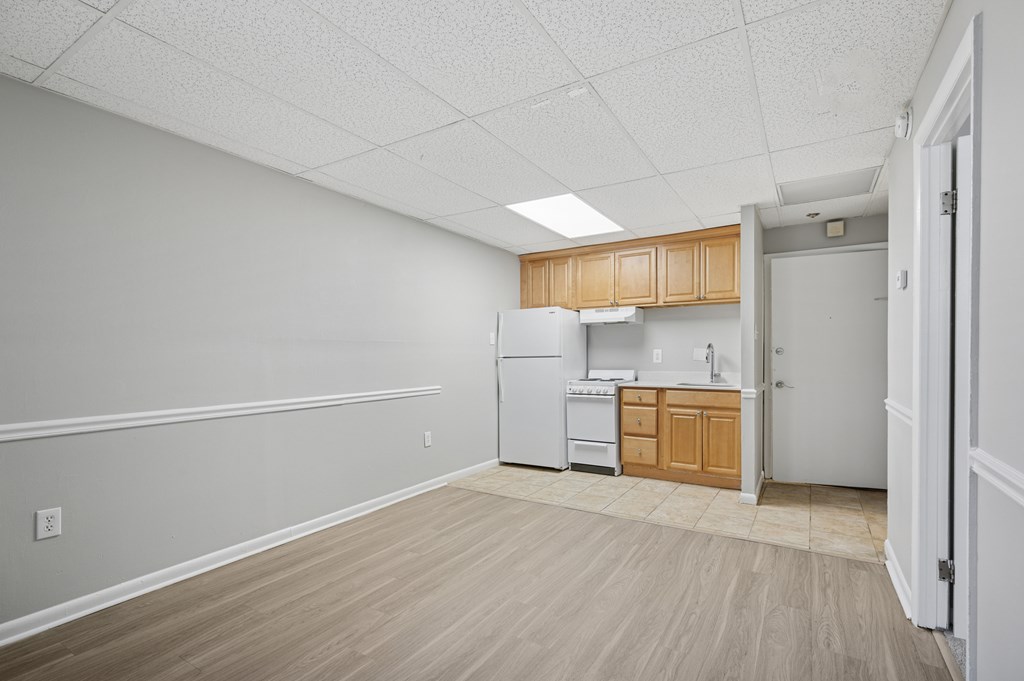 A kitchen area with a refrigerator, oven, and sink.