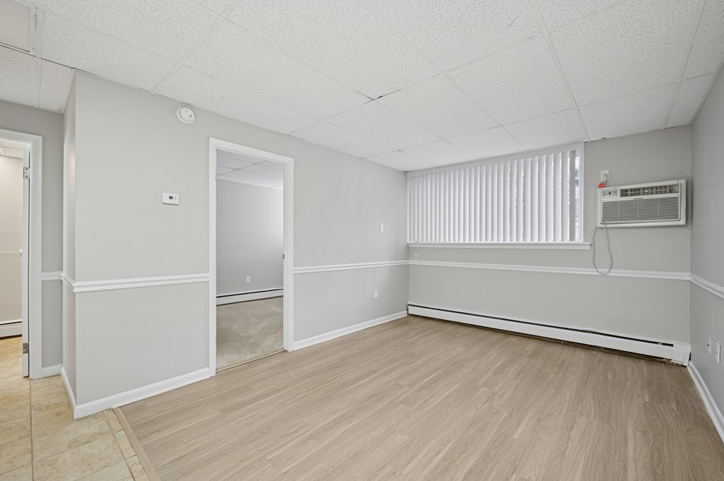A room with a wooden floor and white walls.