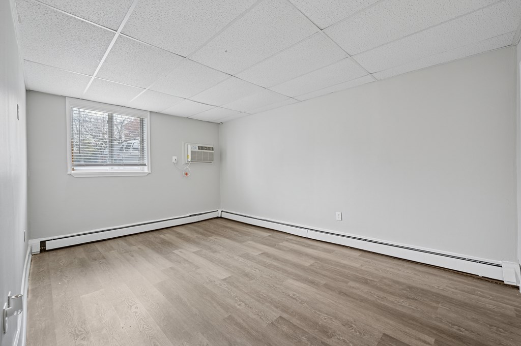 A room with a window and a white ceiling.