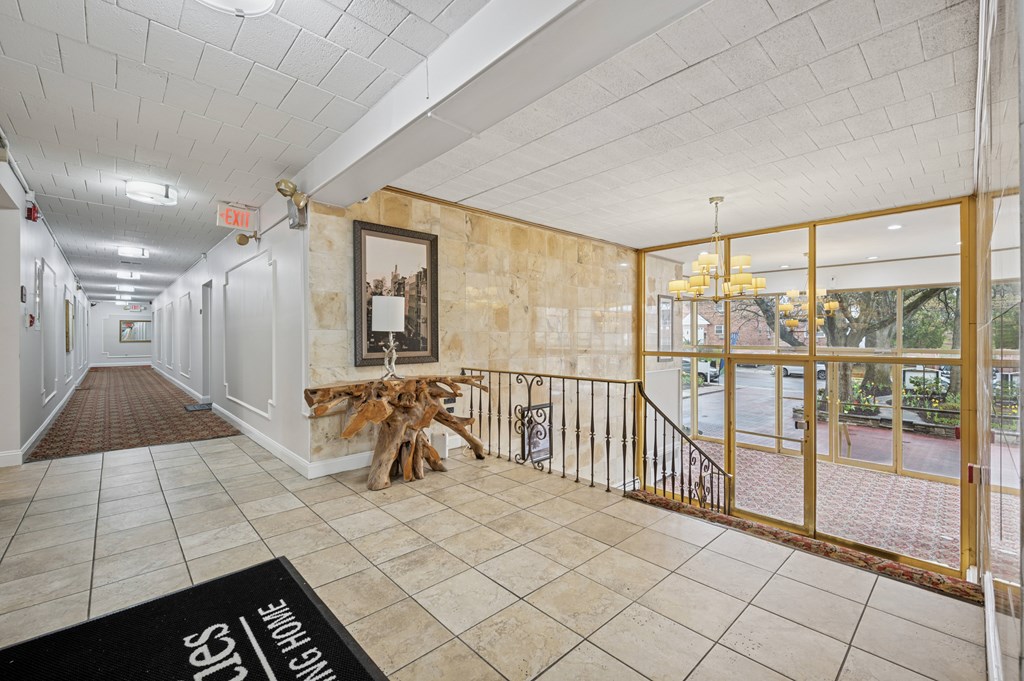 A hallway with a black doormat that says "Welcome" on it.