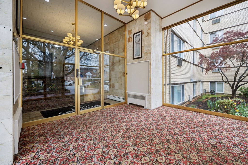 A room with a red carpet and a chandelier.